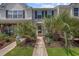 Charming townhome entrance featuring lush tropical landscaping and a welcoming walkway at 807 Wilshire Ln. # 807, Murrells Inlet, SC 29576