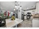 Open kitchen features stainless steel appliances, white cabinets, granite countertops, and wood flooring at 807 Wilshire Ln. # 807, Murrells Inlet, SC 29576