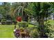 Beautifully landscaped grounds with colorful flowers, mature trees, and a serene pond featuring a fountain at 807 Wilshire Ln. # 807, Murrells Inlet, SC 29576