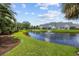 Scenic view of a community pond with fountains, surrounded by lush green lawns and well-maintained townhome exteriors at 807 Wilshire Ln. # 807, Murrells Inlet, SC 29576
