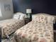 Bedroom decorated with two beds, coastal-themed bedding and decor with a dark blue accent wall at 812 S Ocean Blvd. # B-3, Surfside Beach, SC 29575