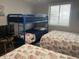 Bright bedroom featuring a bunk bed, two beds with patterned bedding, and a window with blinds at 812 S Ocean Blvd. # B-3, Surfside Beach, SC 29575