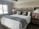 Bedroom with a large bed with designer pillows, side tables and decor at 812 S Ocean Blvd. # B-3, Surfside Beach, SC 29575