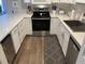 This bright and modern kitchen has updated appliances, stone countertops, and white cabinets at 812 S Ocean Blvd. # B-3, Surfside Beach, SC 29575
