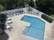 Aerial view of the pool area with lounge chairs and patio furniture, surrounded by lush greenery at 812 S Ocean Blvd. # B-3, Surfside Beach, SC 29575