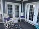 Inviting porch with rocking chairs, decorative pillows, rug, and double doors at 812 S Ocean Blvd. # B-3, Surfside Beach, SC 29575