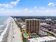 Aerial view of beachfront condos with pool and tennis courts, offering stunning ocean views at 9650 Shore Dr. # 507, Myrtle Beach, SC 29572