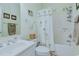 Well-lit bathroom includes a shower-tub combo with a shower curtain featuring palm trees at 1058 Sea Mountain Hwy. # 10-101, North Myrtle Beach, SC 29582