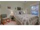 Bedroom with a floral-patterned bedspread and natural light from the window at 1058 Sea Mountain Hwy. # 10-101, North Myrtle Beach, SC 29582