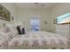 Cozy bedroom featuring floral bedding, a window view, and a television for relaxing comfort at 1058 Sea Mountain Hwy. # 10-101, North Myrtle Beach, SC 29582