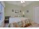Bright bedroom with two twin beds with floral comforters, natural light from window at 1058 Sea Mountain Hwy. # 10-101, North Myrtle Beach, SC 29582