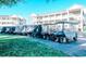 Several covered golf carts sit parked outside of a multi-story condo complex on a sunny day at 1058 Sea Mountain Hwy. # 10-101, North Myrtle Beach, SC 29582