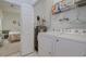 Modern laundry area featuring a washer, dryer, and extra storage shelving at 1058 Sea Mountain Hwy. # 10-101, North Myrtle Beach, SC 29582