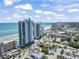 Aerial view of the Oceans One Resort near the beach, other hotels, and various streets with cars at 107 S Ocean Blvd. # 503, Myrtle Beach, SC 29577