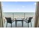 Cozy balcony with seating offering breathtaking views of the sandy beach and sparkling ocean waters at 107 S Ocean Blvd. # 503, Myrtle Beach, SC 29577