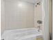 Hotel bathtub and shower combination with jets and a beige tile surround at 107 S Ocean Blvd. # 503, Myrtle Beach, SC 29577