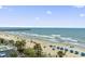 Picturesque view of the beach and ocean from a condo balcony with beachgoers and umbrellas at 107 S Ocean Blvd. # 503, Myrtle Beach, SC 29577