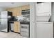 Galley kitchen featuring appliances, cabinets, and a laundry closet at 107 S Ocean Blvd. # 503, Myrtle Beach, SC 29577