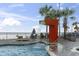 Serene pool area with a waterfall feature, surrounded by palm trees and offering ocean views at 107 S Ocean Blvd. # 503, Myrtle Beach, SC 29577
