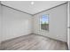 Bedroom showcasing wood-look floors and neutral walls, plus a window overlooking the new construction landscape at 108 Forman Way, Aynor, SC 29511