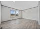 Bright bedroom features two windows and gray wood-look flooring at 108 Forman Way, Aynor, SC 29511