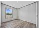 Bedroom featuring wood-look floors, neutral walls and trim, with a window view of new construction area at 108 Forman Way, Aynor, SC 29511