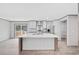 Bright kitchen features a center island, stainless steel appliances, white cabinets, and wood-look floors at 108 Forman Way, Aynor, SC 29511