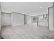 Bright open living area boasts wood-look flooring, natural light, and a glimpse of the modern kitchen at 108 Forman Way, Aynor, SC 29511