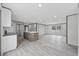 Bright, open floor plan showcasing kitchen with island, wood-look flooring, and abundant natural light at 108 Forman Way, Aynor, SC 29511