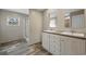 Bathroom with a double vanity, wood-look floors, and a view of a shower area at 109 Forman Way, Aynor, SC 29511