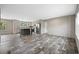 An open-concept living and dining area features wood-look floors and neutral-colored walls at 109 Forman Way, Aynor, SC 29511