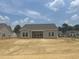 Newly built home with a covered patio and large windows in a spacious, undeveloped backyard at 119 Westfield Circle, Conway, SC 29526