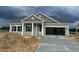 Charming new home with beige siding, gray roof, and open garage on a cloudy day at 119 Westfield Circle, Conway, SC 29526