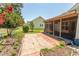 Backyard view featuring patio, screened in porch, and manicured landscaping at 123 Retreat Pl., Little River, SC 29566