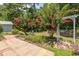 Beautifully landscaped backyard with flowering trees, brick patio, and white garden arch at 123 Retreat Pl., Little River, SC 29566