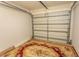 Spacious garage interior showing the closed door and a decorative rug on the floor at 123 Retreat Pl., Little River, SC 29566
