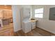 Functional laundry area featuring a stacked washer/dryer and a built-in desk for added convenience at 123 Retreat Pl., Little River, SC 29566