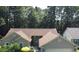 An aerial view showcases this home's roof, complemented by lush landscaping and mature trees surrounding the property at 1307 Carolina Wren Ln., Murrells Inlet, SC 29576