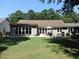 Spacious backyard features a large, well-maintained lawn and patio seating area perfect for relaxing at 1307 Carolina Wren Ln., Murrells Inlet, SC 29576