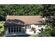 This backyard features a patio area with seating, a grill, and access to green space and mature trees at 1307 Carolina Wren Ln., Murrells Inlet, SC 29576