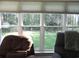 Backyard view with patio seating and mature trees from large windows at 1307 Carolina Wren Ln., Murrells Inlet, SC 29576