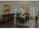 Elegant dining room with a table set for six, stylish lighting, and hardwood floors at 1307 Carolina Wren Ln., Murrells Inlet, SC 29576