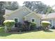 Charming single-story home with beautiful landscaping including colorful flowers and manicured bushes in the front yard at 1307 Carolina Wren Ln., Murrells Inlet, SC 29576