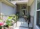 View of front entrance featuring an ornamental iron fence and gate with potted plants and a ceiling fan at 1307 Carolina Wren Ln., Murrells Inlet, SC 29576