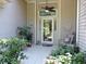 Inviting front porch with seating, ceiling fan, and decorative plants near front door at 1307 Carolina Wren Ln., Murrells Inlet, SC 29576