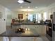 Open concept kitchen with granite countertops, island, stainless steel appliances, and views to dining space at 1307 Carolina Wren Ln., Murrells Inlet, SC 29576