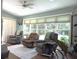 Living room featuring recliners, ceiling fan, skylight, and backyard view at 1307 Carolina Wren Ln., Murrells Inlet, SC 29576