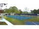 Outdoor tennis courts showcasing well-maintained playing surfaces and surrounding greenery for an active lifestyle at 1307 Carolina Wren Ln., Murrells Inlet, SC 29576