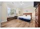 Inviting bedroom with a large window providing natural light and wood-style flooring at 139 Avian Dr. # 6-201, Pawleys Island, SC 29585