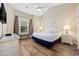 Bedroom featuring wood floors, a ceiling fan, and a large window at 139 Avian Dr. # 6-201, Pawleys Island, SC 29585